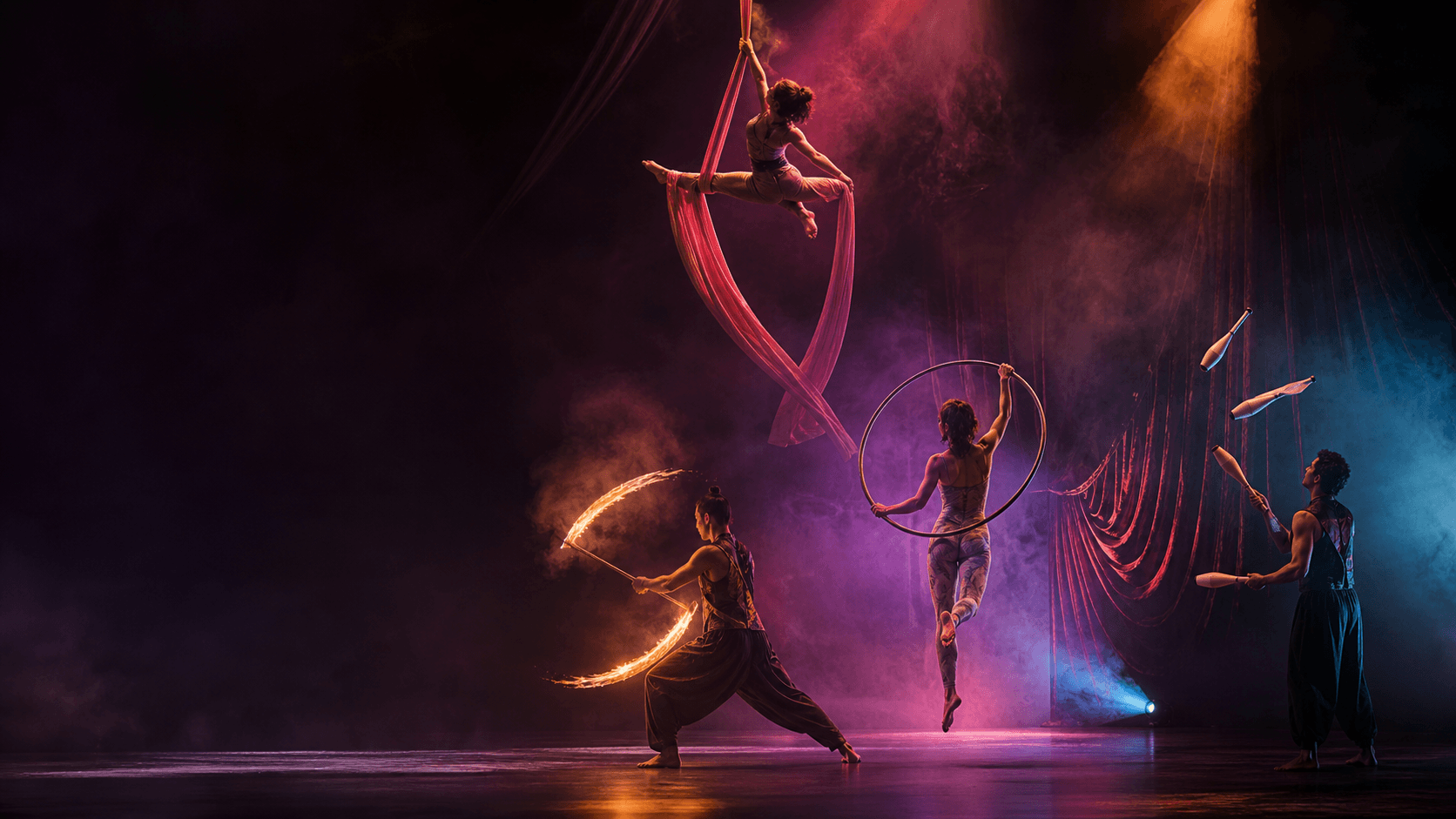 Contemporary circus artists performing aerial silks, lyra, fire, and juggling on a theater stage